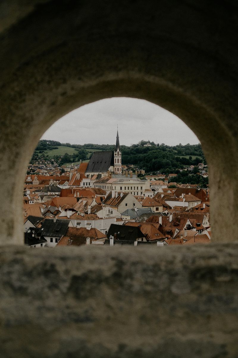 Town seen through a stone arch