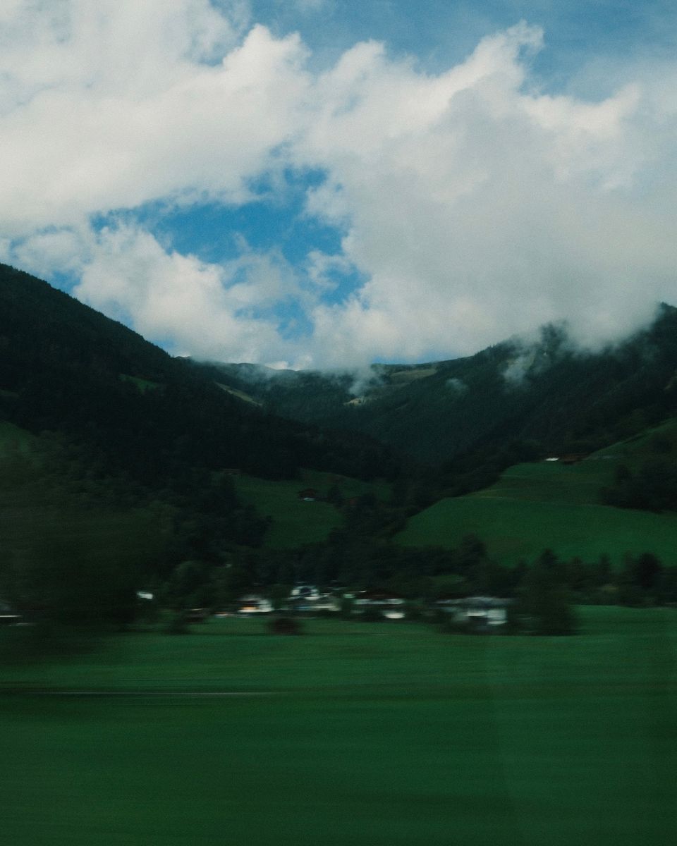 Green valley under clouds