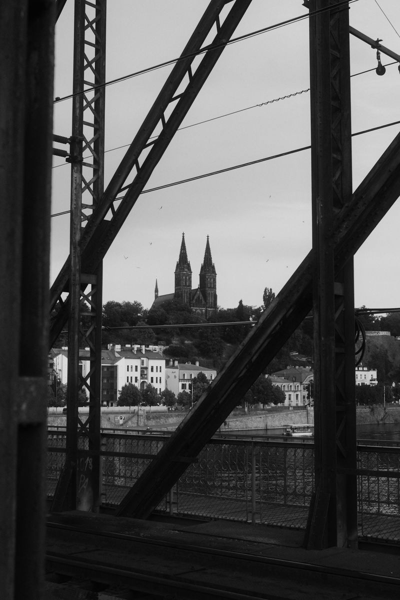 Bridge truss framing church spires, black and white
